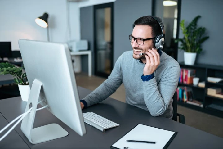 A man helping a client over the phone.